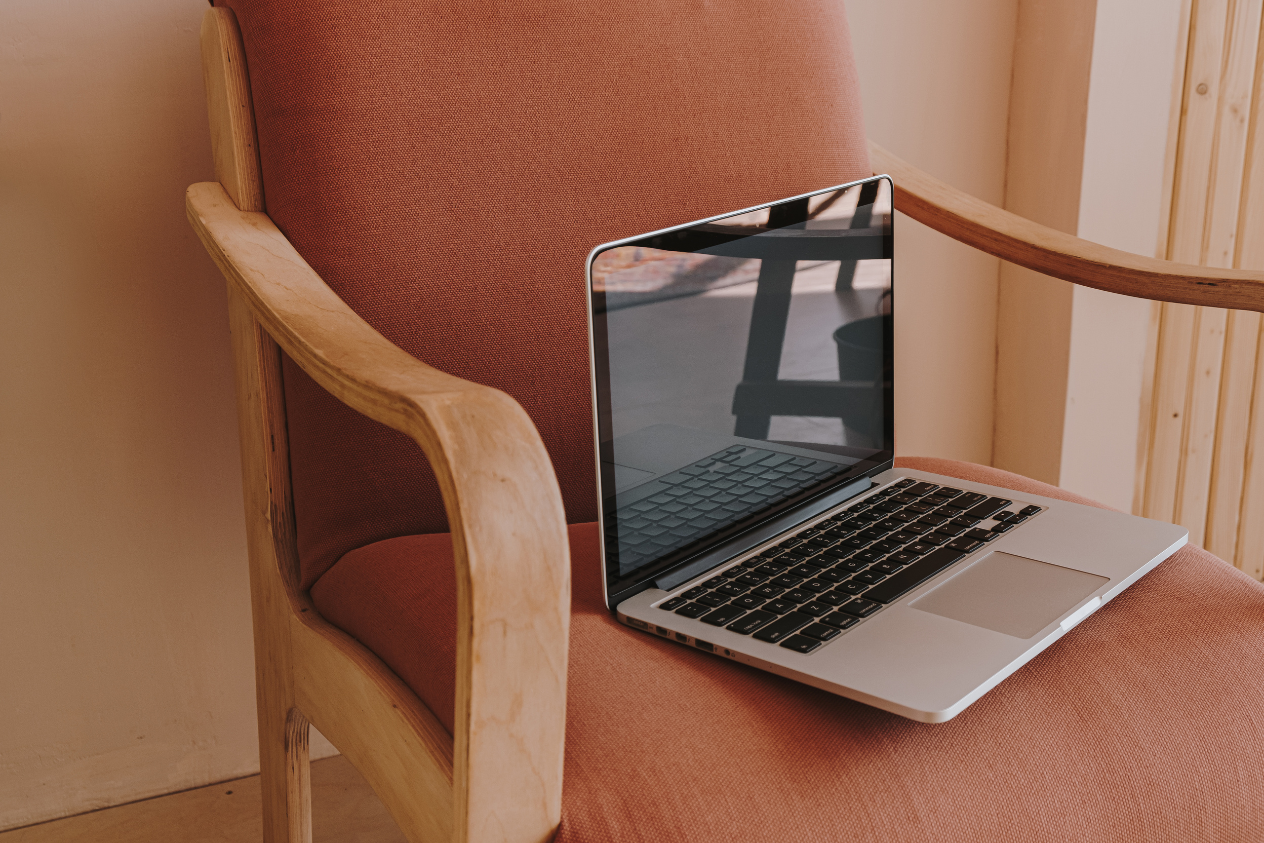 Laptop on a Brown Chair